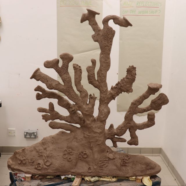 A clay sculpture of an organic shape inspired by moss habitats and microscopic plants and organisms.