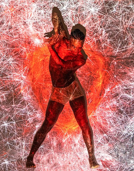 A red tinged image of a person mid dance. They are simply wearing a pair of short shorts.
