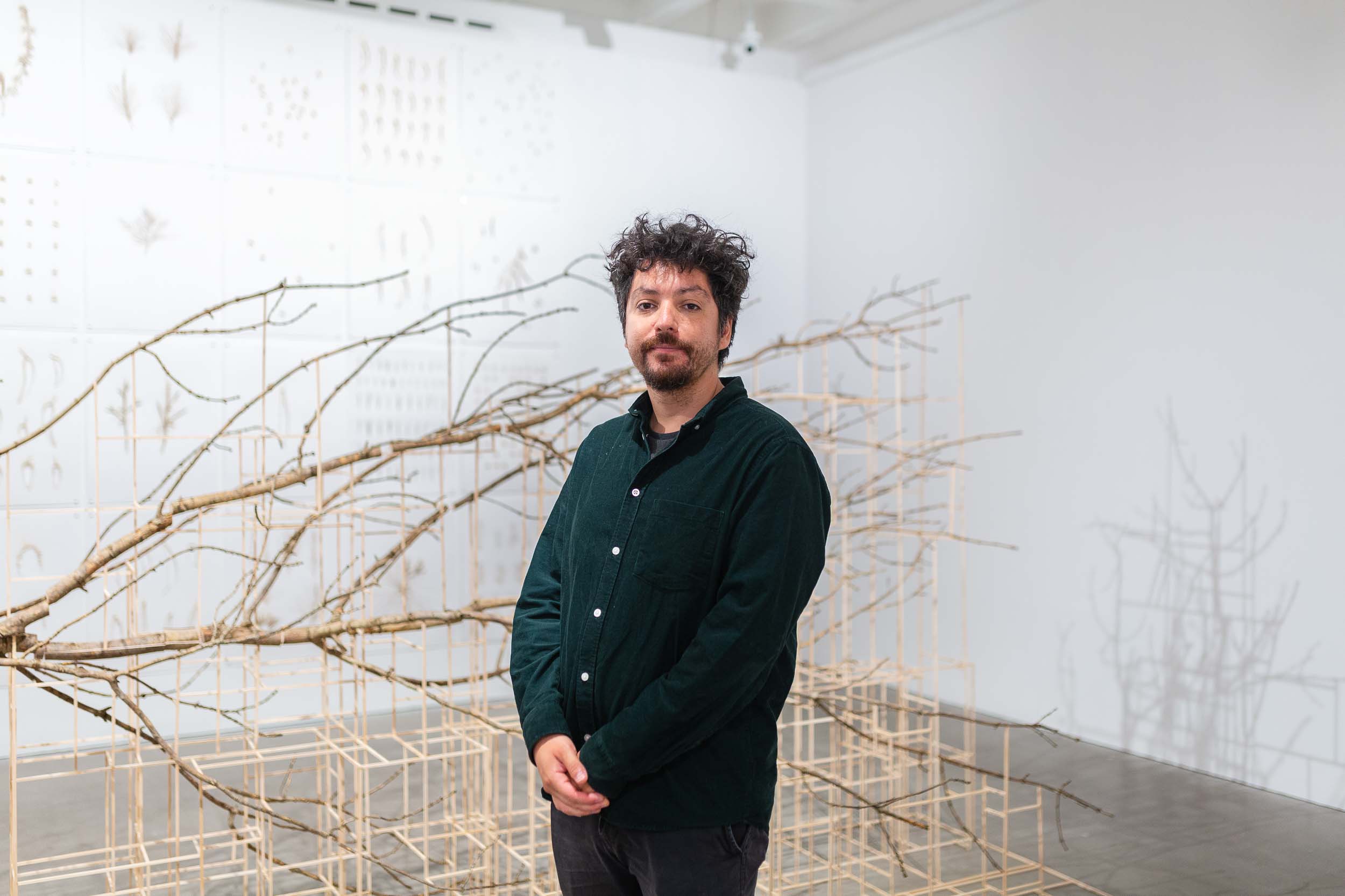 Artist Rodrigo Arteaga taken next to his work Fallen Tree, part of Forest: Wake This Ground exhibition at Arnolfini in 2022.