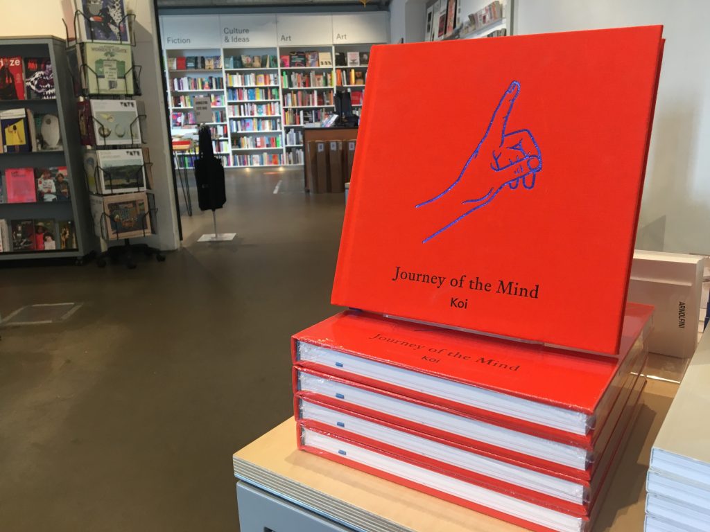 A colour photograph of a pile of Journey of the Mind books in the foyer outside Arnolfini Bookshop.