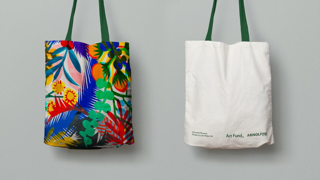 A colourful, patterned tote bag covered in vibrantly coloured patterns and leaf shapes with a dark green handle.