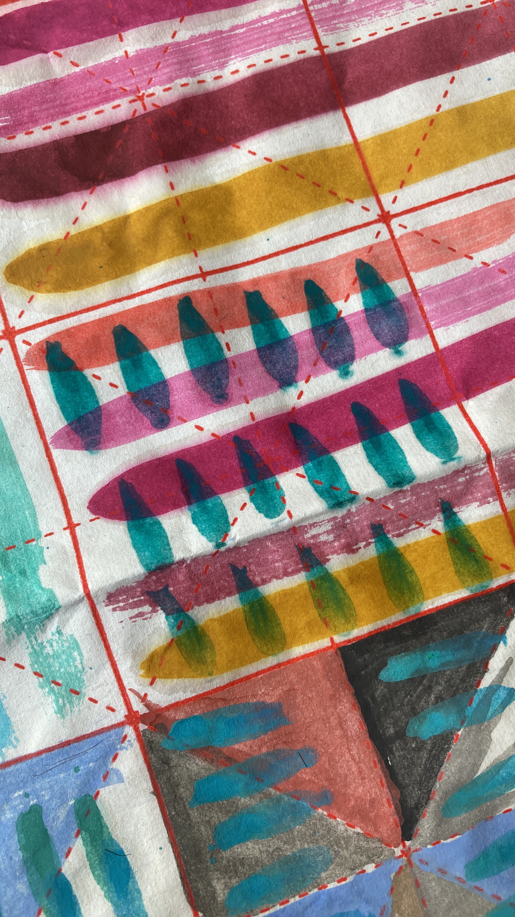 A close up image of a piece of white paper with colourful designs painted in watercolour